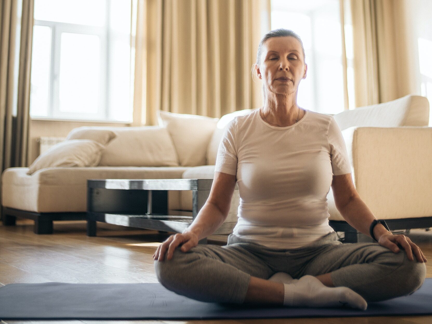 A woman practicing trauma informed yoga, one of the six common betrayal trauma treatments.